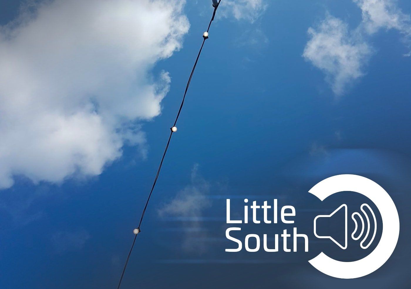 A little south logo with a blue sky in the background