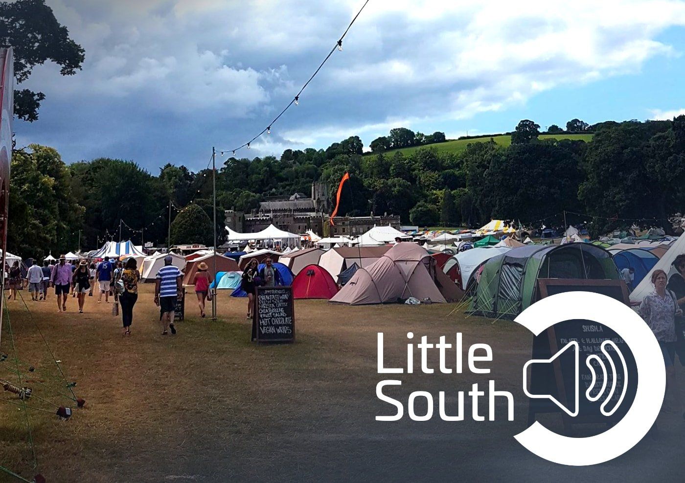 A group of people walking in a field with the words little south on the bottom
