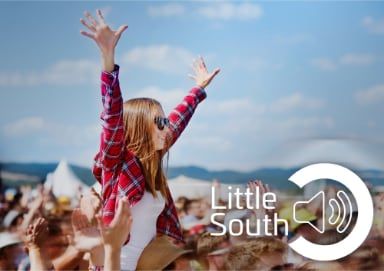 A woman with her arms in the air at a little south event