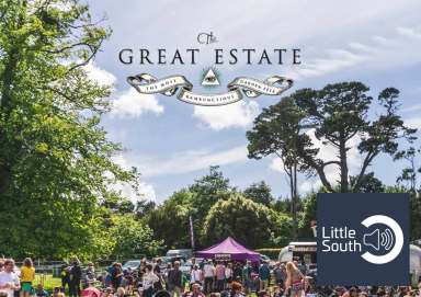 A group of people are gathered in a park under a sign that says great estate