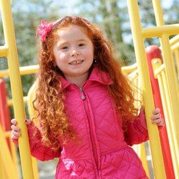 Little girl with pink jacket smilling- Childcare in Bayville, NJ Little girl with pink jacket smilling- Childcare in Bayville, NJ