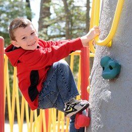 Little boy with red jacket climbing- Childcare in Bayville, NJ Little boy with red jacket climbing- Childcare in Bayville, NJ