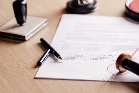 Trial Lawyer Office — Contract Paper With Sign Pen And Water Mark Under the Wood Table In Poca, WV Trial Lawyer Office — Contract Paper With Sign Pen And Water Mark Under the Wood Table In Poca, WV