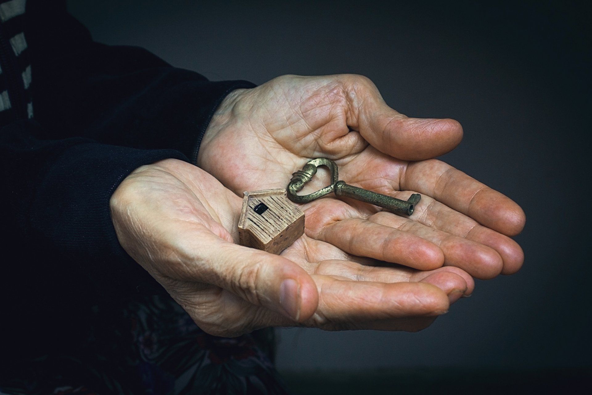 Powers Of Attorney — Dirty Palm Of A Woman With Key And Tiny House in Poca, WV Powers Of Attorney — Dirty Palm Of A Woman With Key And Tiny House in Poca, WV