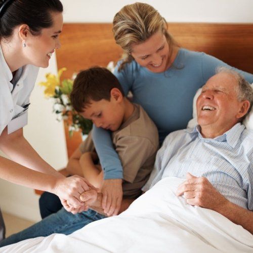 old man enjoying time with his daughter son and nurse