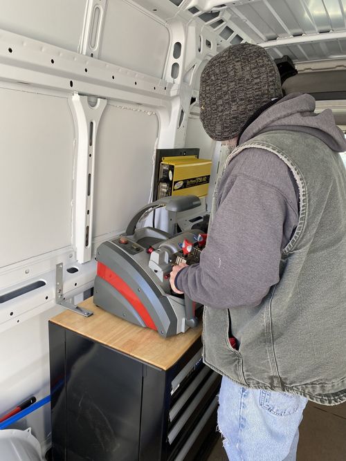 Man Using Key Machine — Lanconia, NH — Bob’s Lock & Key LLC Man Using Key Machine — Lanconia, NH — Bob’s Lock & Key LLC