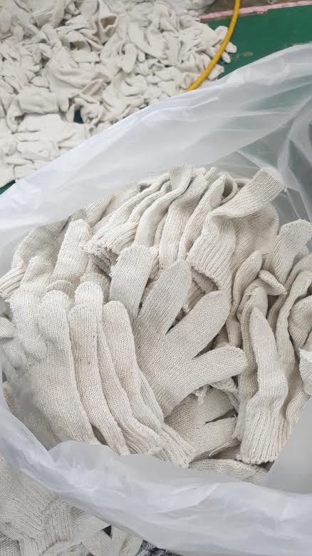 A pile of white gloves in a plastic bag.