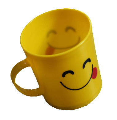 A yellow mug with a smiley face on it