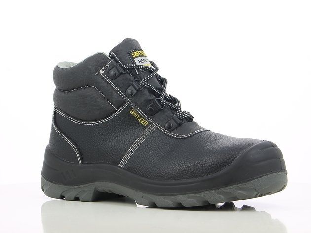 A pair of black safety boots are sitting on a white surface.
