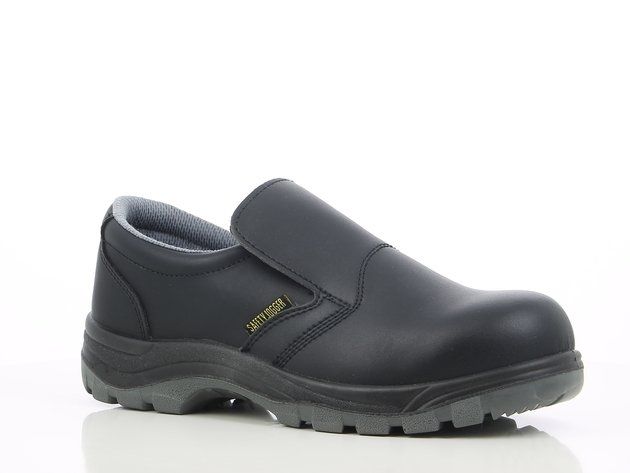 A pair of black safety shoes on a white surface.