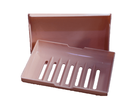 A brown plastic soap dish with holes in it