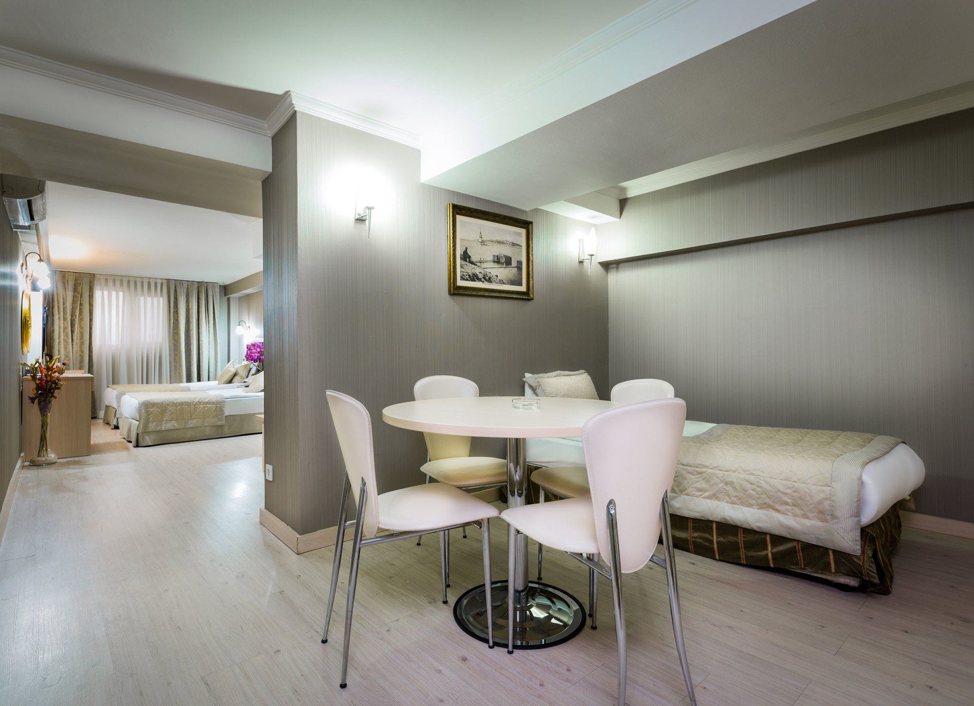There is a table and chairs in the middle of the room.