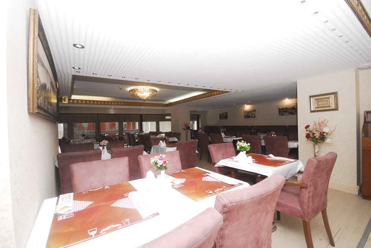 A restaurant with tables and chairs set up for dinner