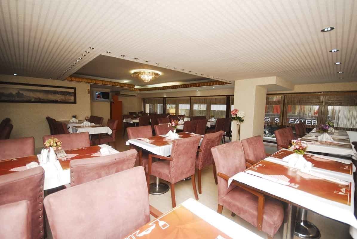 A restaurant with tables and chairs in a large room