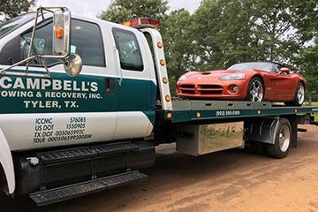 Flatbed truck hauling a sports car