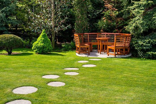 Plants — Sunny Day in a Spring Garden With Wooden Benches in Morris Plains, NJ
