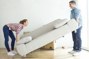 Portrait of pretty young couple moving in new home.