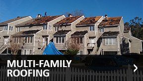 Roofing Shingles — Residential Roof in Savannah, GA Multi-family buildings with roofs being replaced, blue tarp, sunny day.