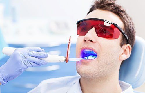 man wears UV safety goggles while receiving laser treatment.