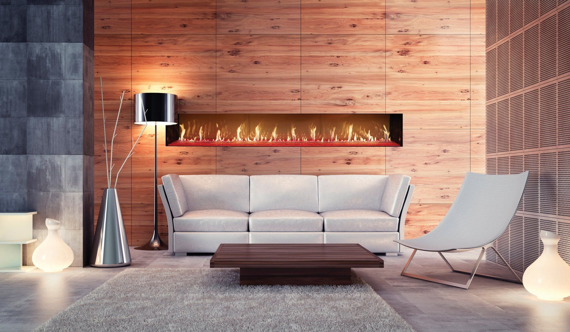 Modern living room with fireplace, white couch, armchair, wooden wall, and warm lighting.