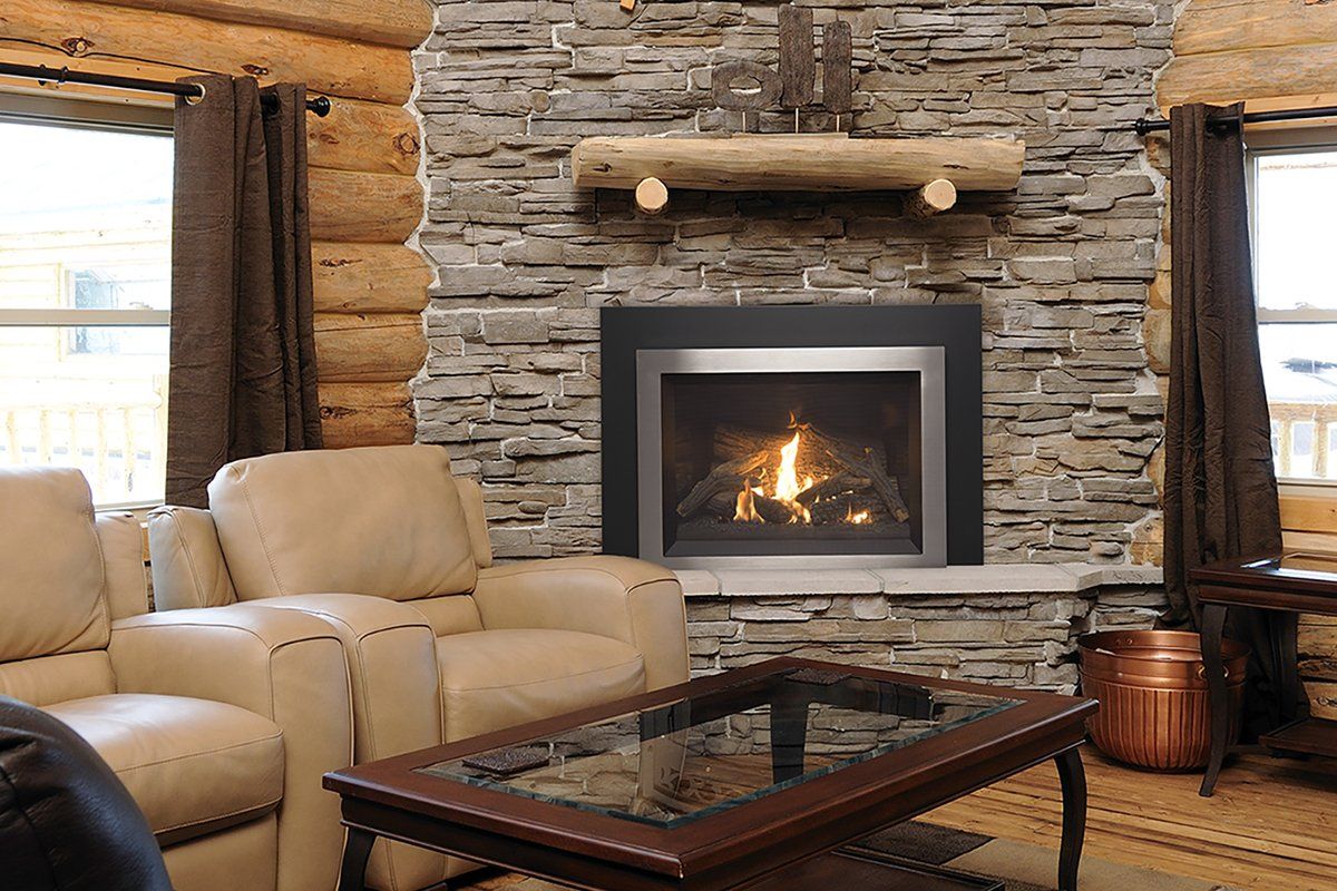 Cozy living room with fireplace, stone wall, log beams, leather furniture, and glass-top coffee table.