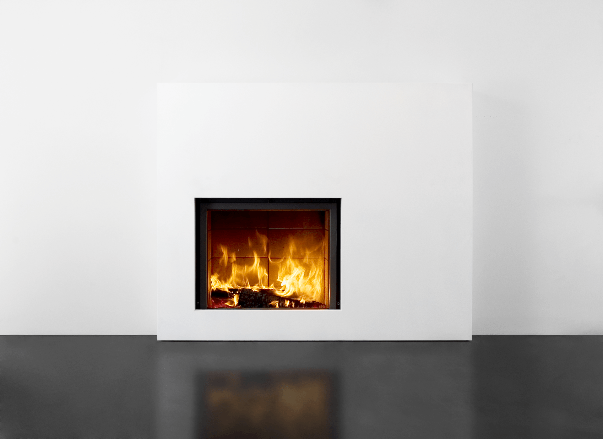 White fireplace with flames against a white wall and glossy black floor; fire's reflection visible.