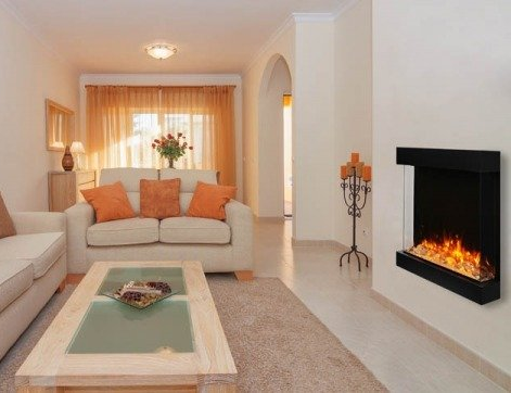 Living room with couch, coffee table, and electric fireplace on a white wall.