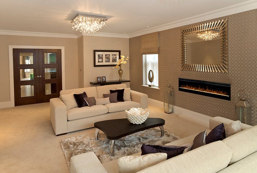 Living room with two white sofas, a black coffee table, a fireplace, and a large mirror.
