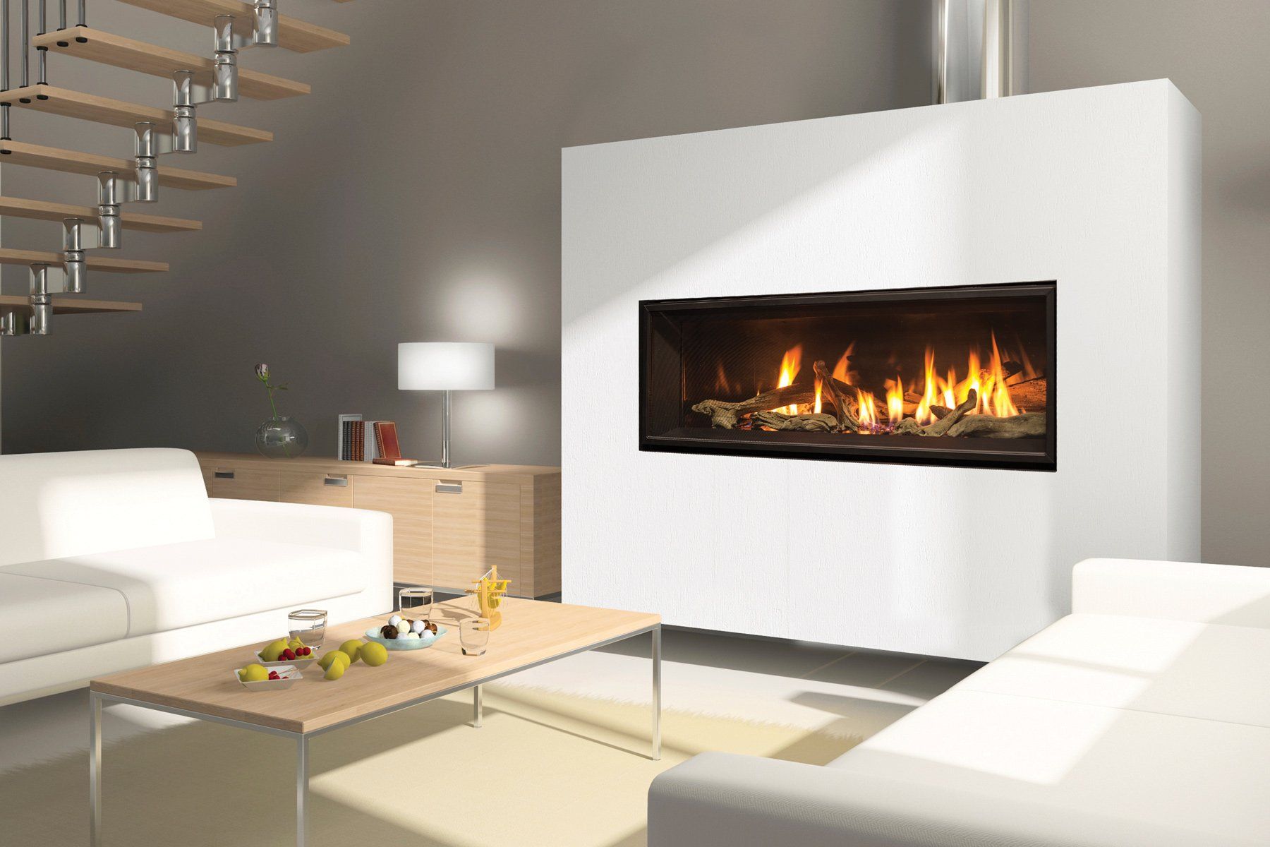 Modern living room with fireplace, white walls, and furniture. Staircase and side table visible. Fire is lit.