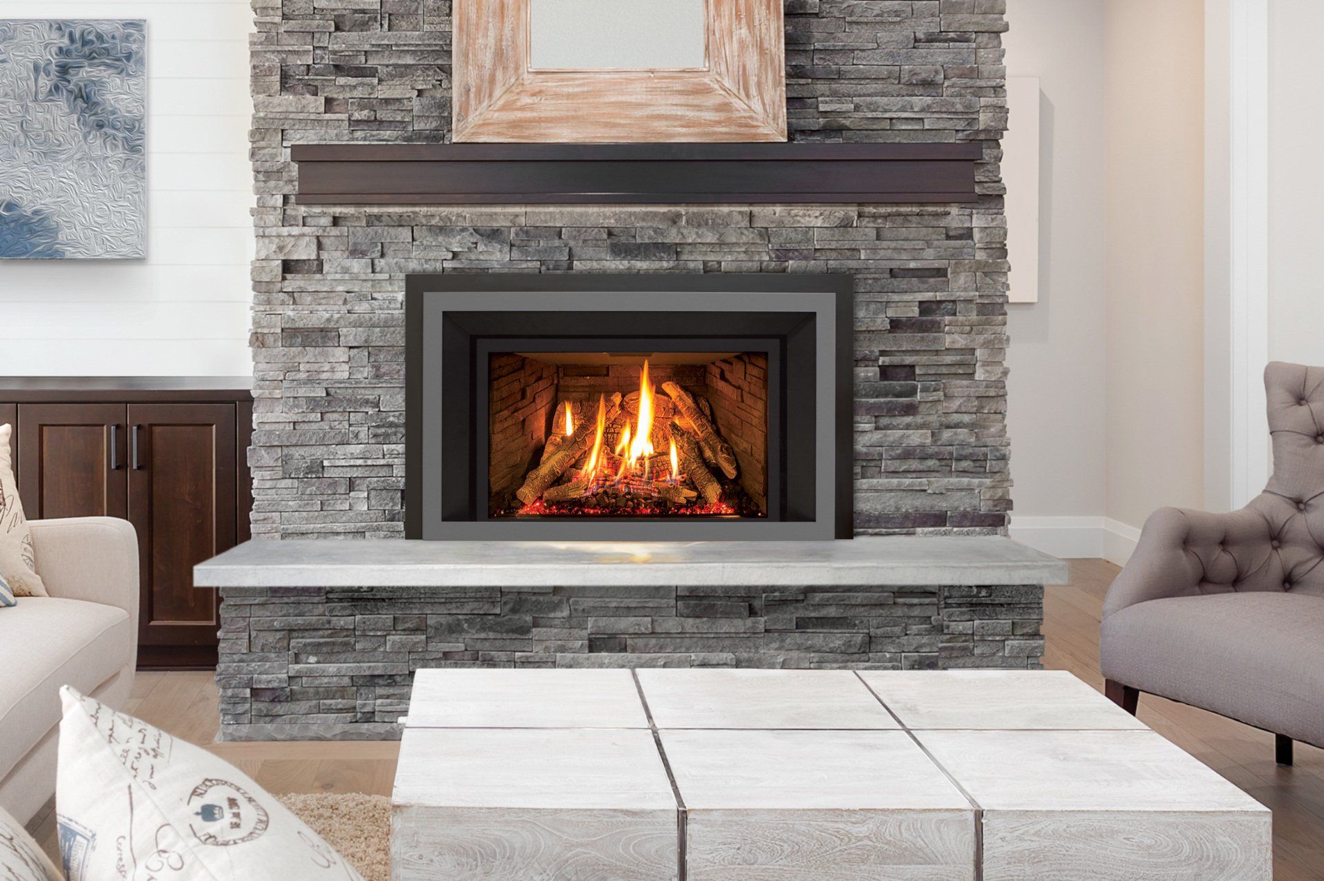 Fireplace with burning logs, gray stone surround, dark mantel. Modern living room setting.