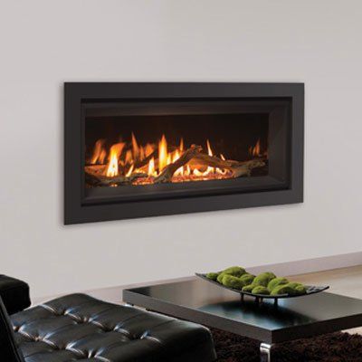 Black-framed gas fireplace on a white wall, with burning flames and decorative logs.