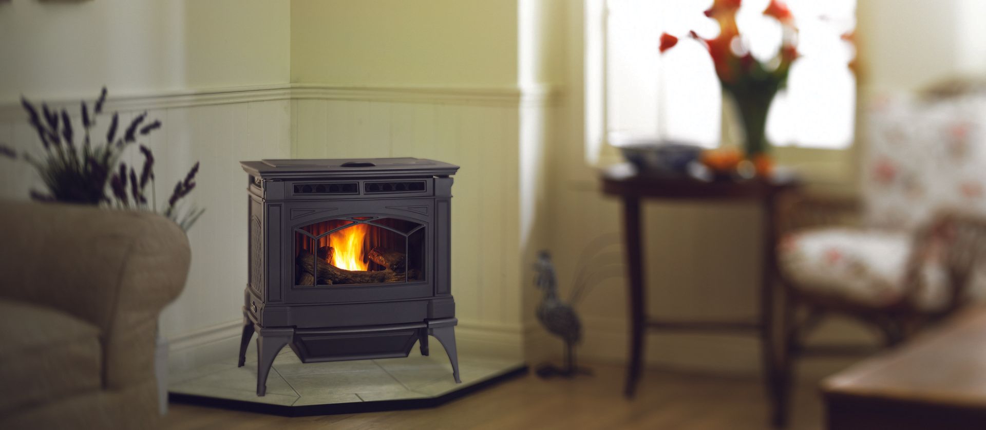 A black pellet stove with a glowing fire in a living room.