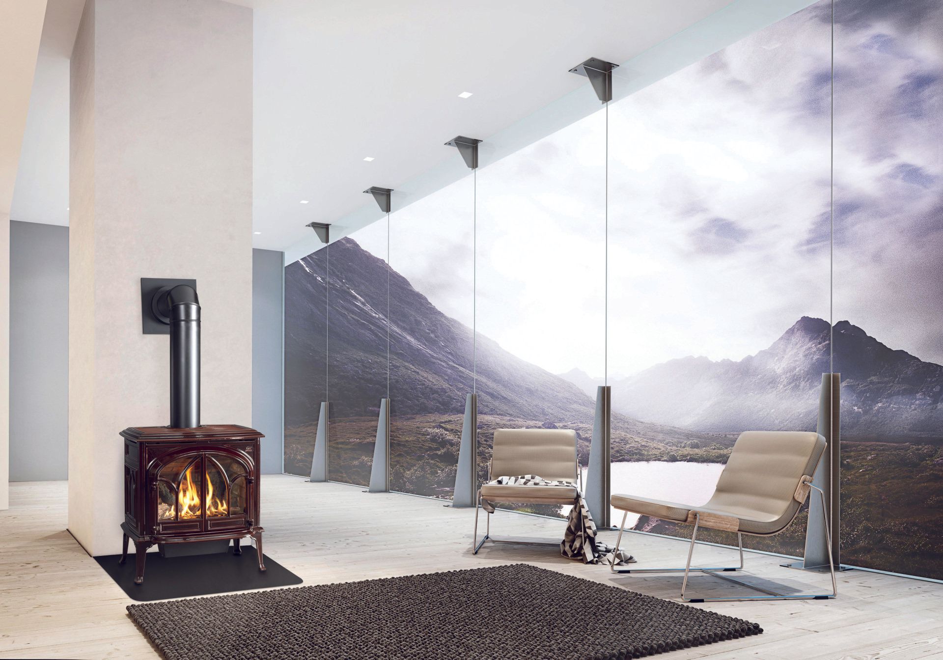 Living room with a fireplace, chairs, and a large window with a mountain landscape.