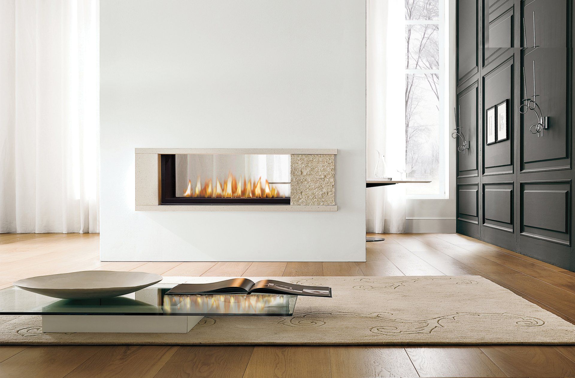 Modern living room with a built-in fireplace, light-colored walls, wood floor, and a patterned rug.