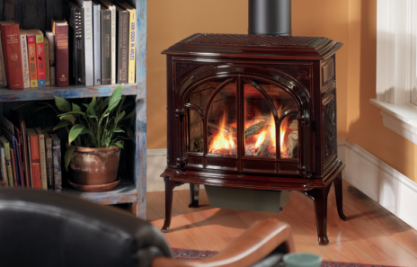 Dark brown gas fireplace with flames, in a living room, next to a bookshelf.