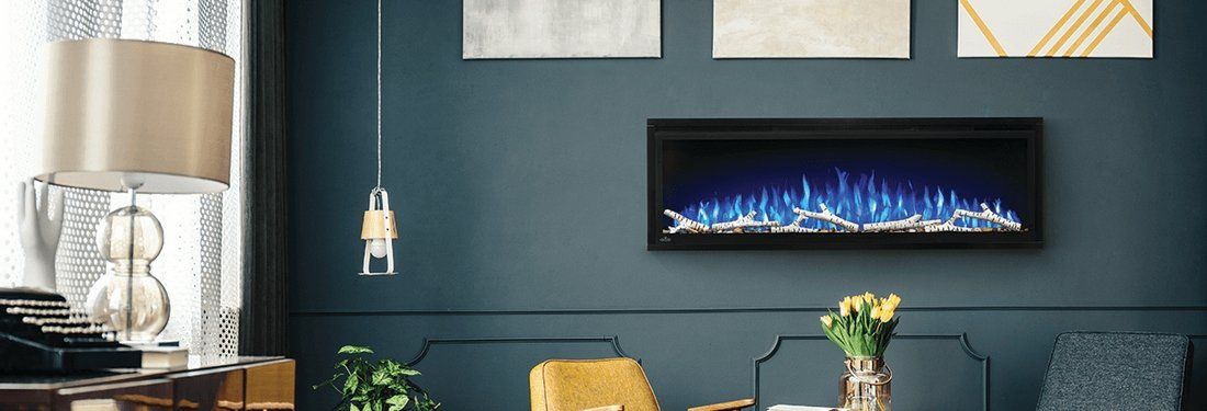 Modern room with blue accent wall, electric fireplace, and abstract art.