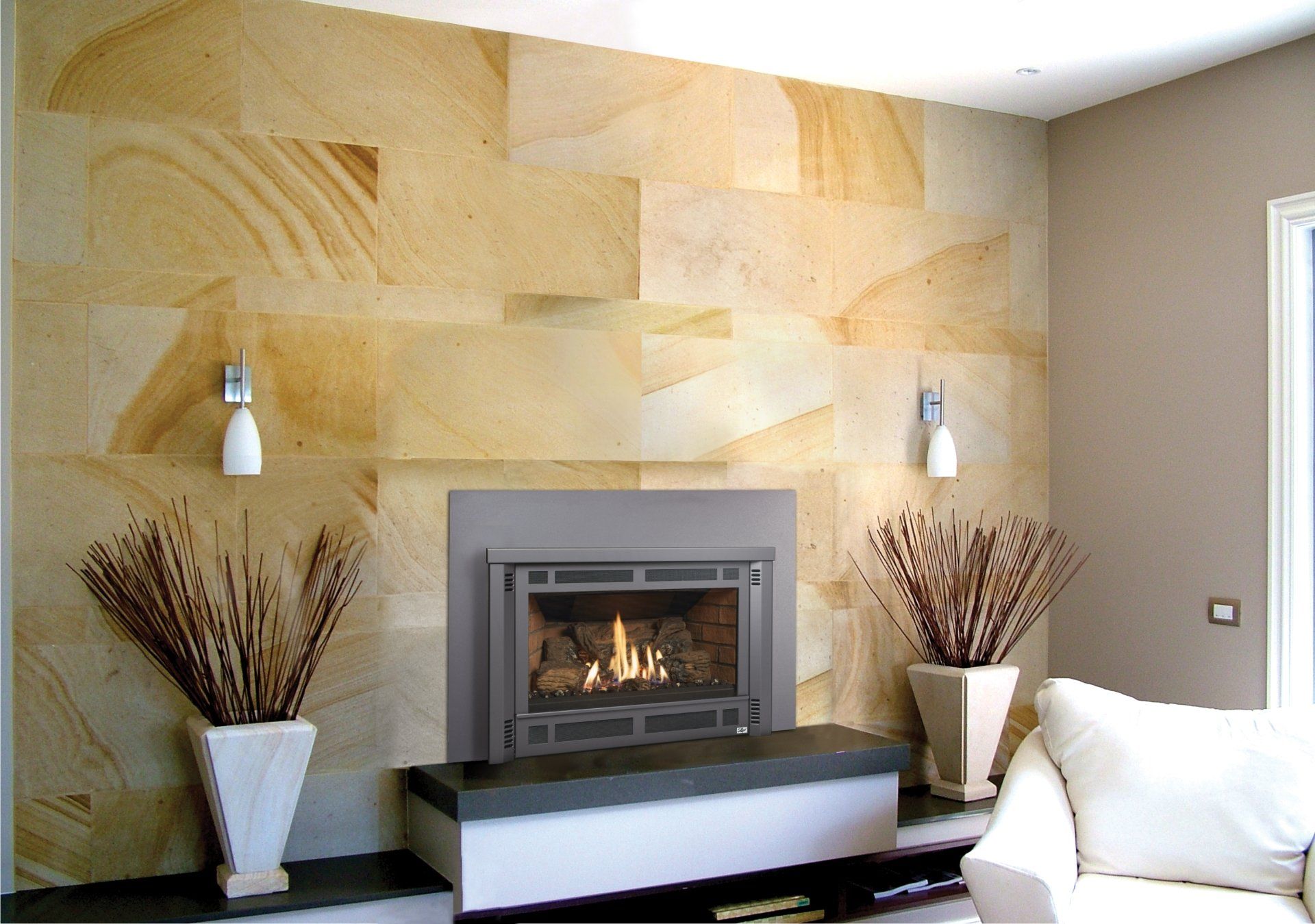 Fireplace in a modern living room, stone wall backdrop, two decorative plants, white couch.