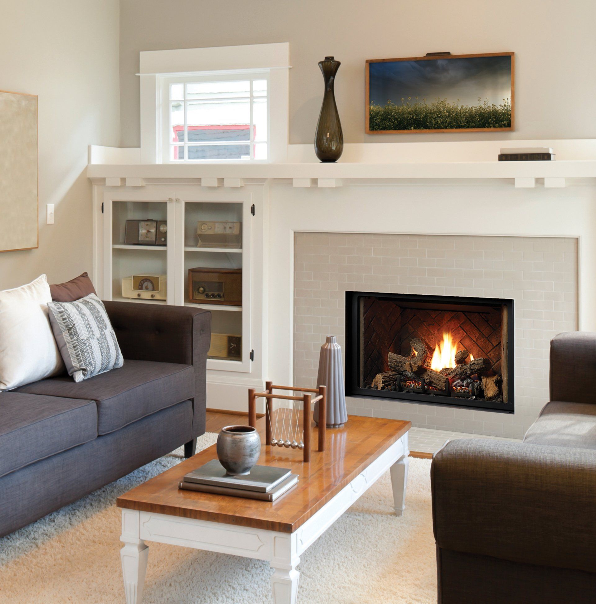 Cozy living room with fireplace, brown sofa, white coffee table, and a built-in cabinet.