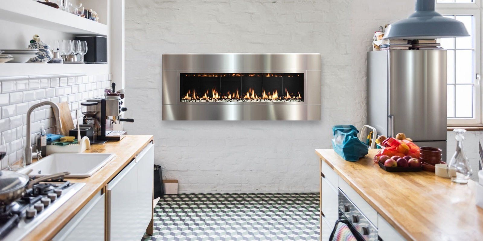 A modern kitchen with a stainless steel fireplace on the wall. Wood countertops, white cabinetry, and a black and white tiled floor.
