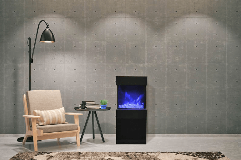 Living room scene with armchair, floor lamp, and electric fireplace against concrete wall.