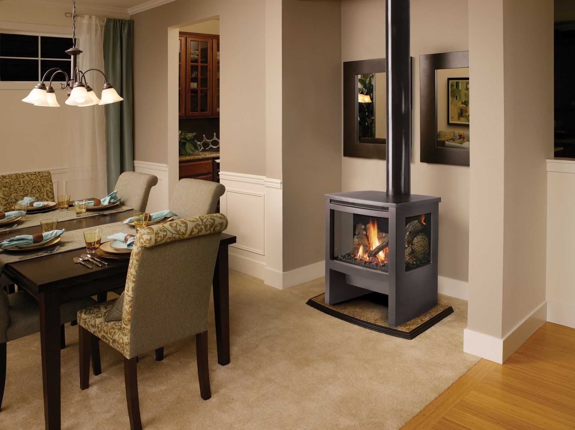 Dining room with a gas fireplace and a table set for a meal. The room is decorated in neutral colors.