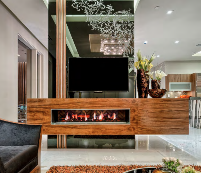 Modern living room with fireplace and mounted TV on a wooden structure.