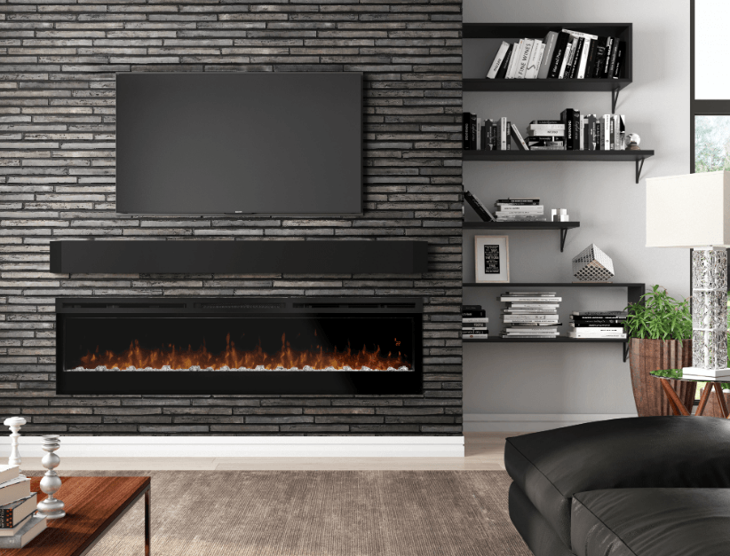 Living room with brick wall, fireplace, TV, floating shelves with books, and a black leather sofa.