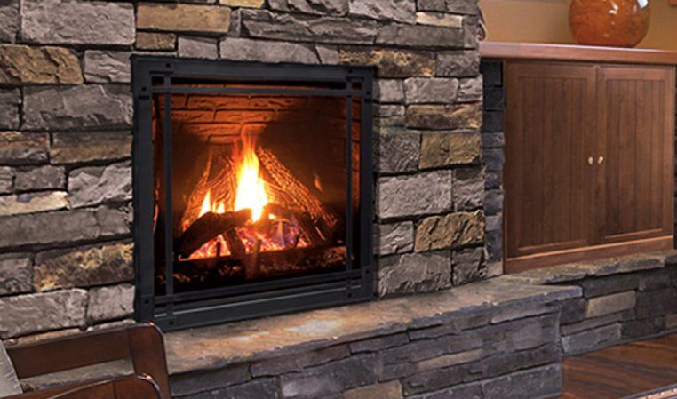 Fireplace with burning logs, encased in a stone wall. Black frame. Warm orange glow.