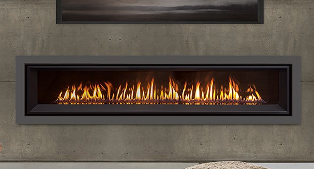 Fireplace with flickering flames, encased in a dark frame against a gray concrete wall.