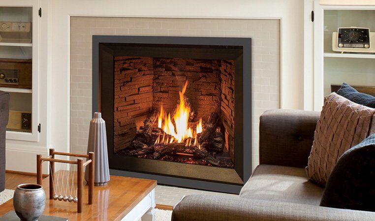 Fireplace with flames in a living room; a gray border surrounds the opening.