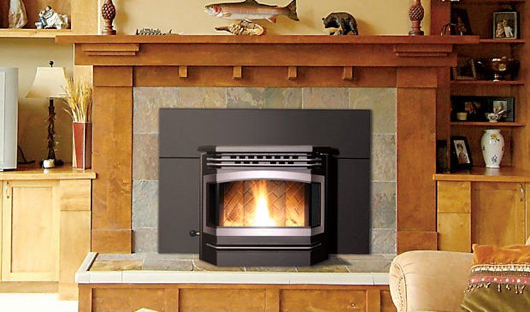Fireplace with wooden mantel and shelves, lit fire in black stove.