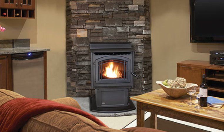 Pellet stove with flames in a stone hearth, cozy living room setting.