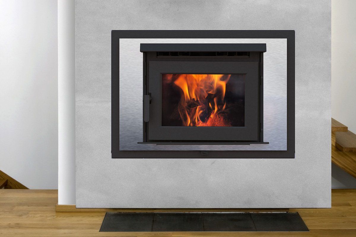 Fireplace with burning flames, enclosed in a dark frame and set in a grey wall.