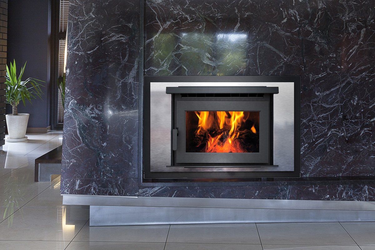 Fireplace with burning flames in a dark marble surround.